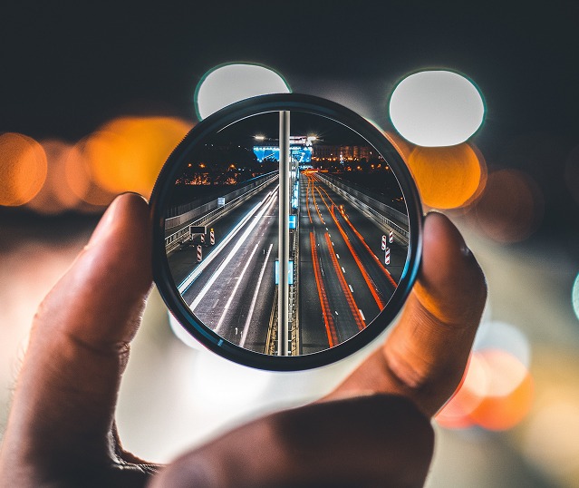 Magnifying lens over traffic representing ML arteka governance of enterprise platforms
