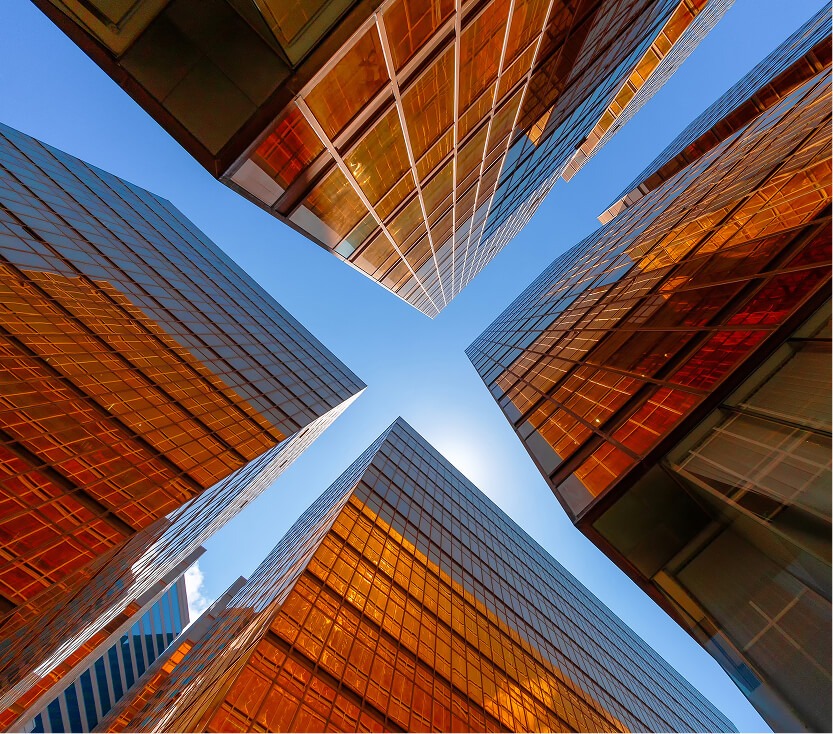 Modern glass towers representing ML arteka secure modernization for financial services