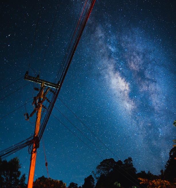 Milky Way above power lines representing dependencies governed in ML arteka cloud delivery