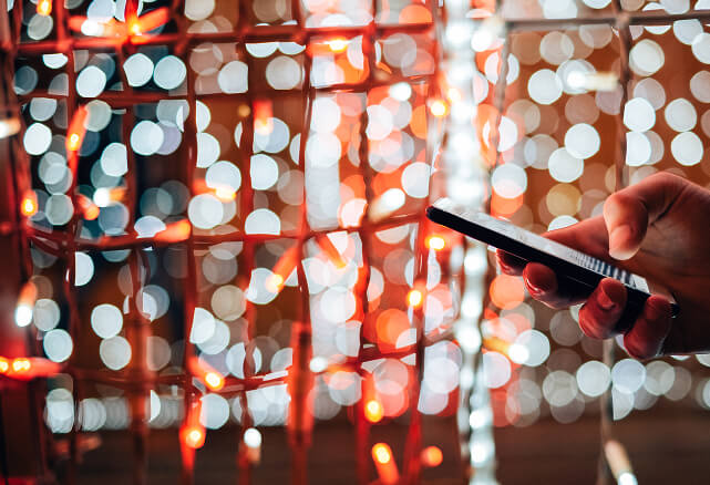 Smartphone against connected lights representing ML arteka privacy-compliant telecom analytics